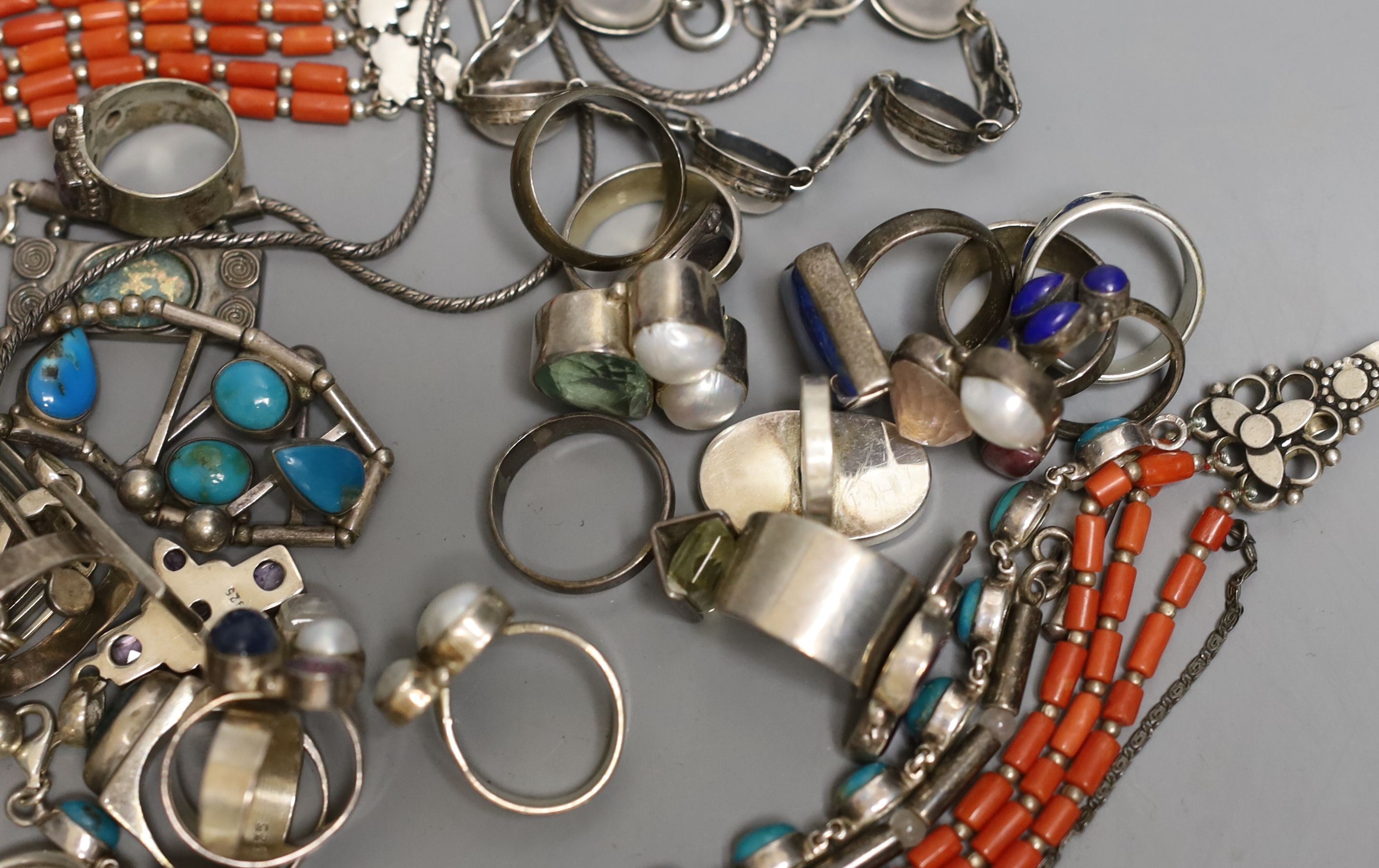 A quantity of mainly modern silver and white metal jewellery including gem set rings.